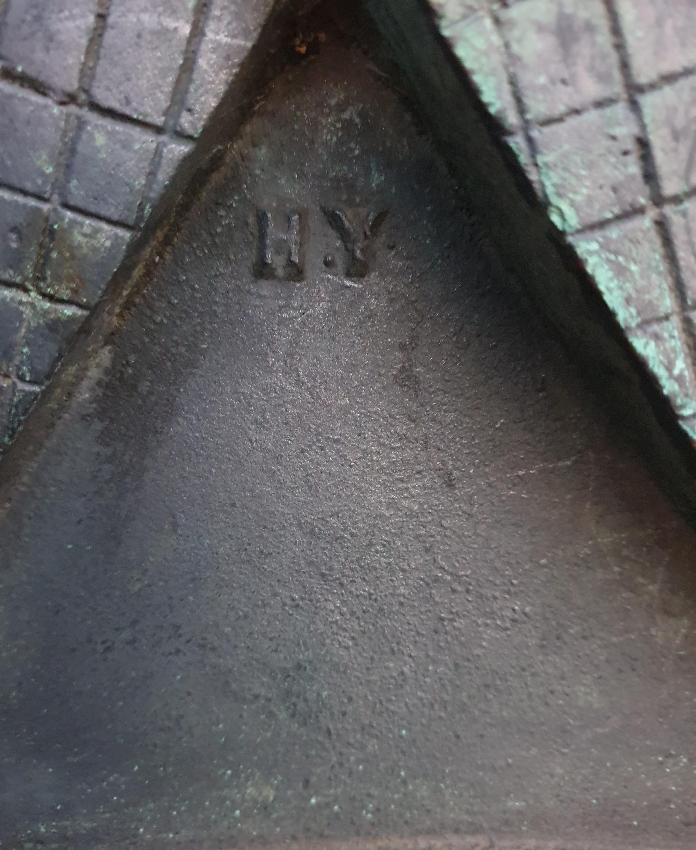 The initials of Herbert Yates tucked between the two shields on the plaque