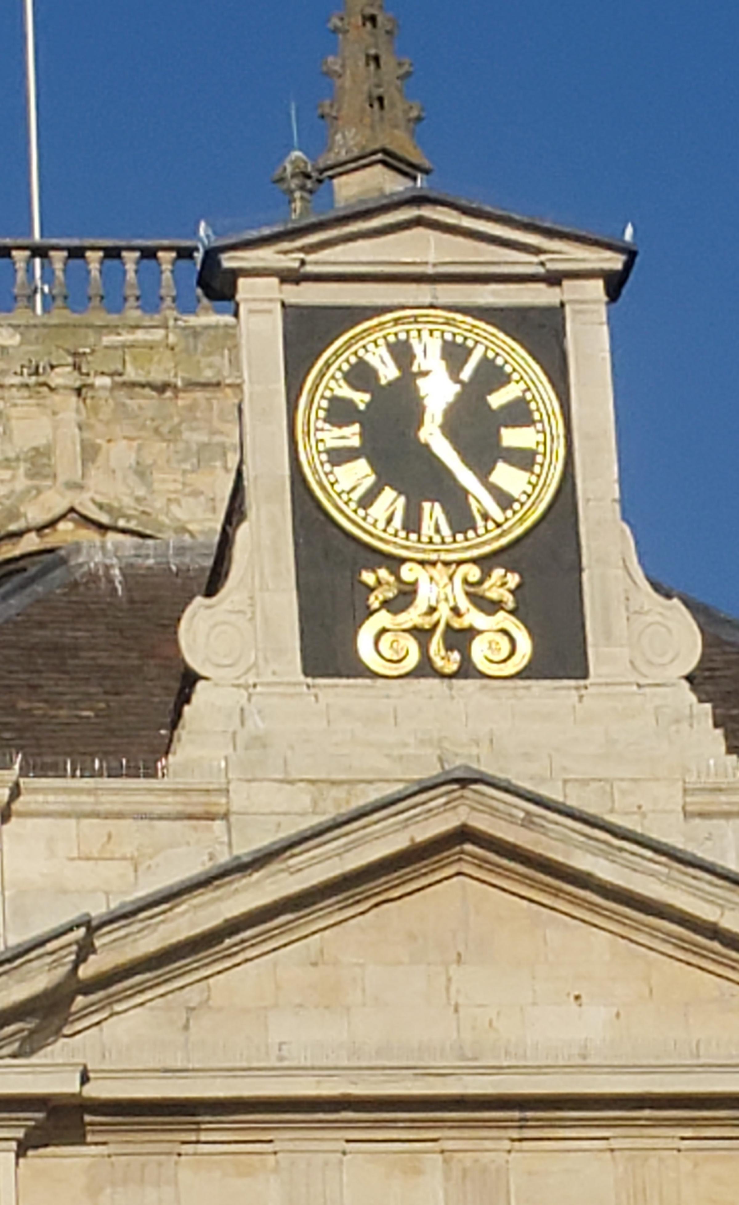 Above which building will you see this clockface? 